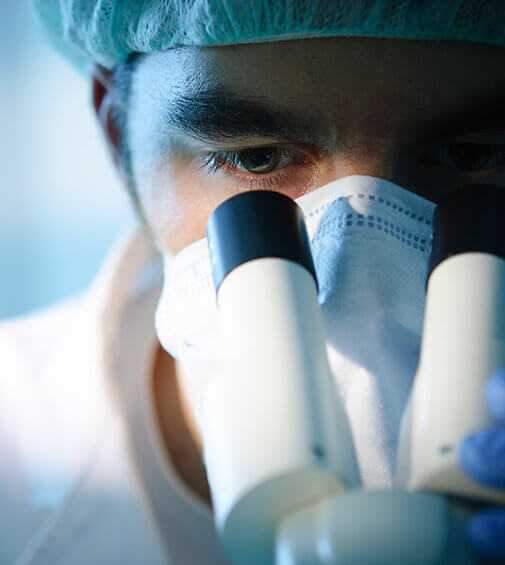 Man looking into microscope