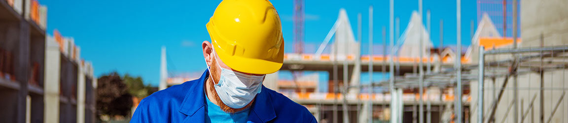 Hard hat construction worker wearing a mask