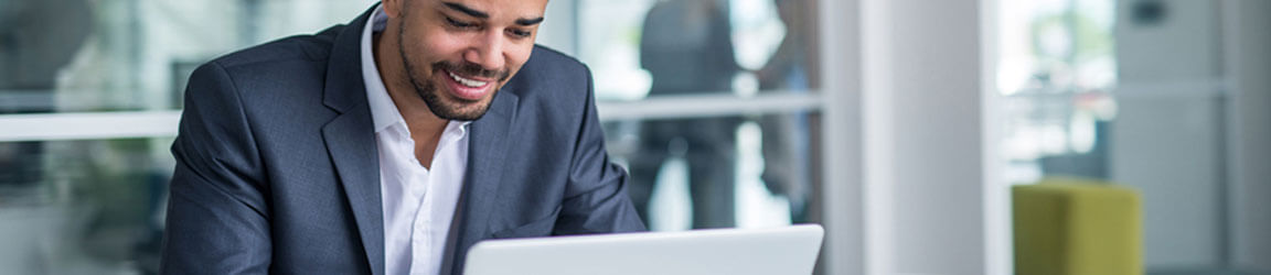 Professional man using laptop in an office