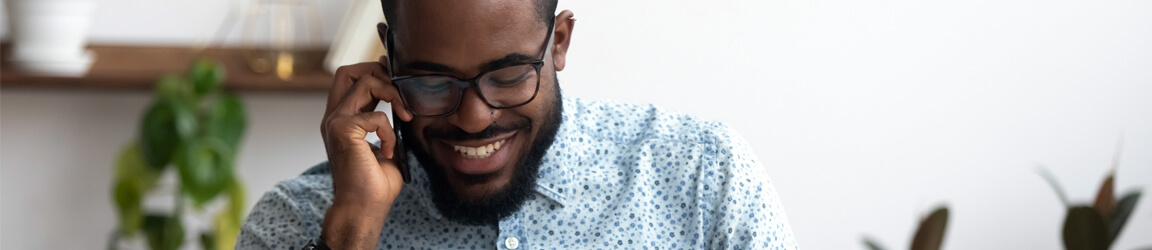 man smiling while on a phone call